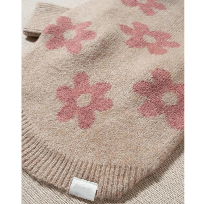 Close-up of the pink flower knit pattern and ribbed hem
