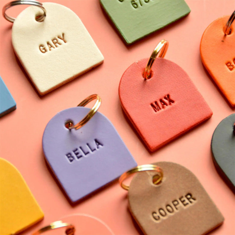 Embossed leather name charms in pastel colors