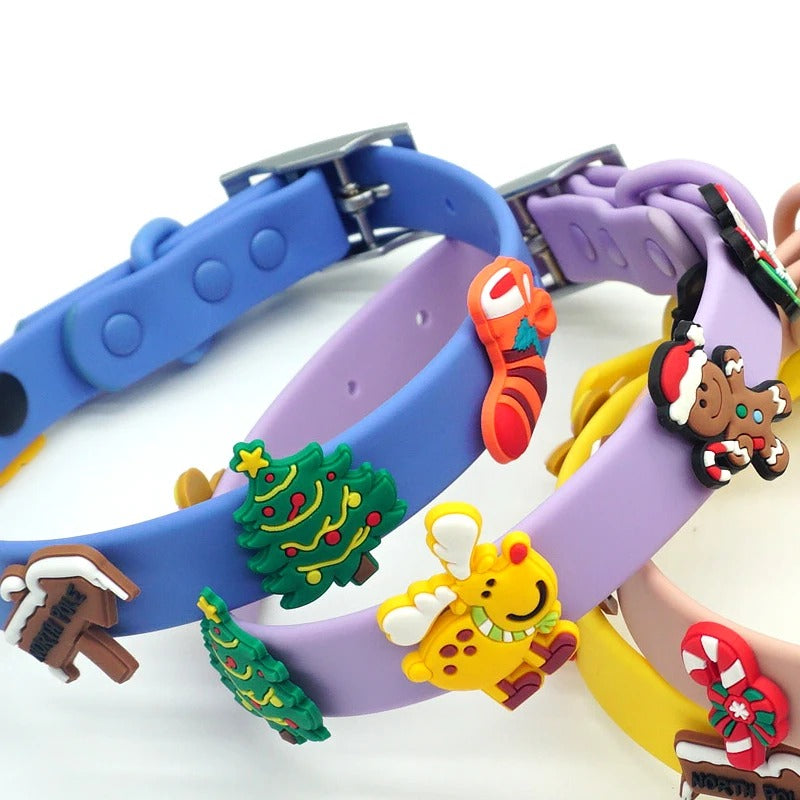 Close-up of Christmas tree, stocking, reindeer and gingerbread charms on blue and lavender dog collars