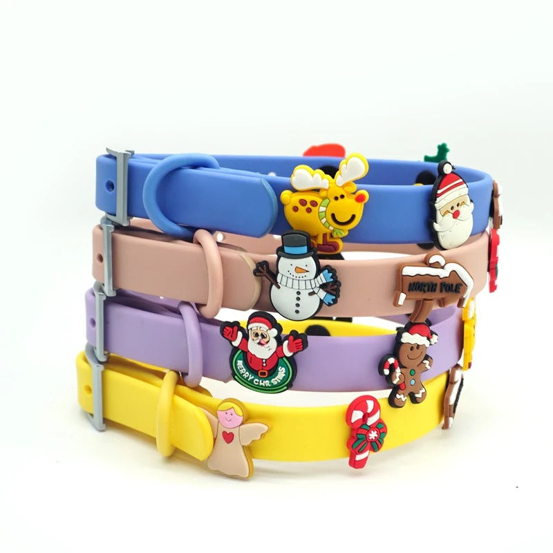 Stack of pastel dog collars decorated with Santa, snowman, reindeer, gingerbread and candy cane charms